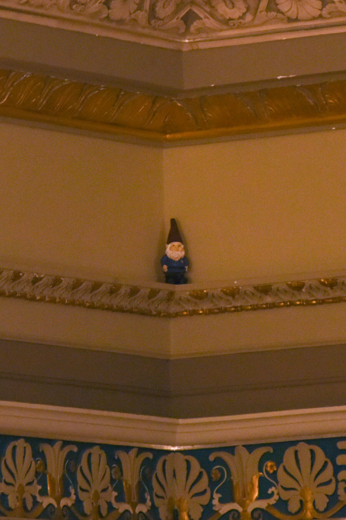 A gnome sits on a ledge